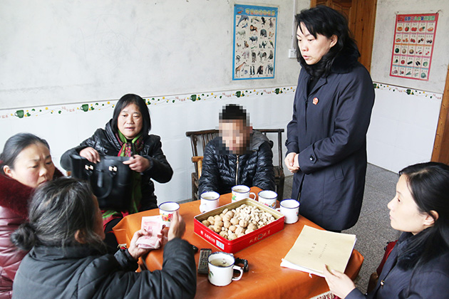 何雅俐法官与司法局同志向吴兵（化名）送去医疗费.JPG